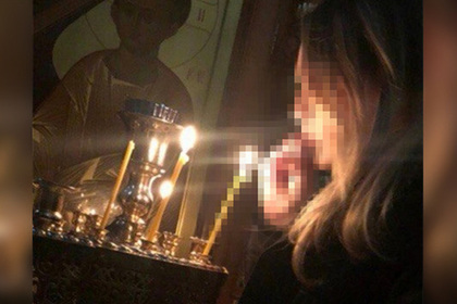 Девушка попыталась прикурить сигарету от свечи в церкви