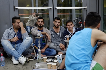 Выходцы с Ближнего Востока у центра приема беженцев в Гамбурге